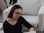 A woman reading, looking concerned