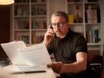 A picture of a man on the phone, looking concerned