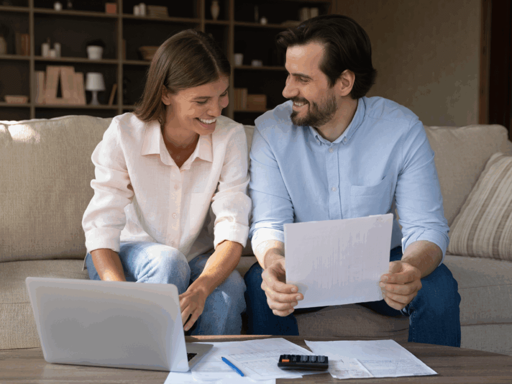 A couple at home doing financial paperwork.
