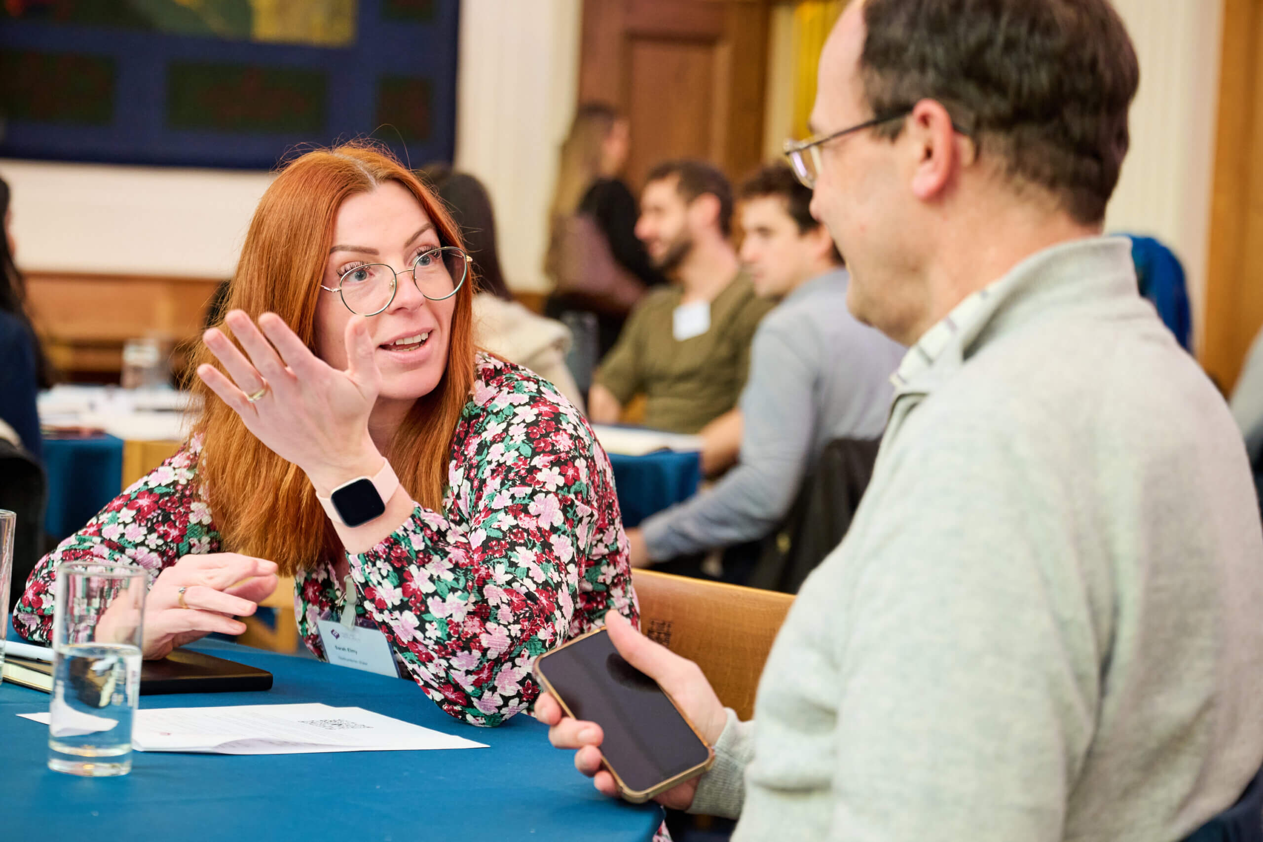 Two attendees in discussion at our data sharing event.