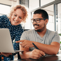Two people looking at a laptop