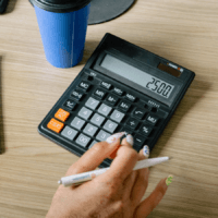 A hand using a calculator.