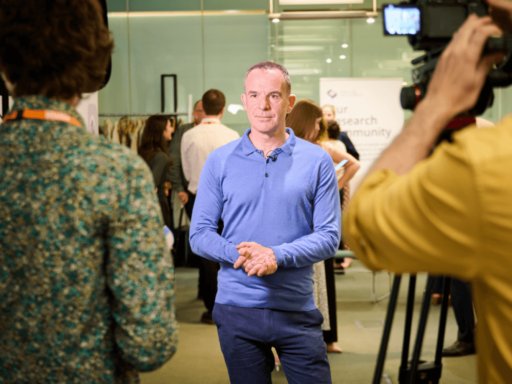 Martin Lewis preparing to be filmed at an event.