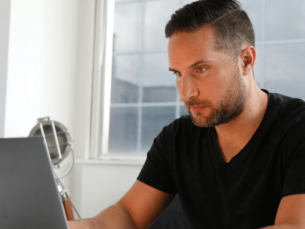 Man sat at a laptop.