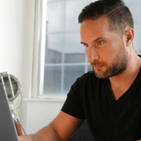 Man sat at a laptop.